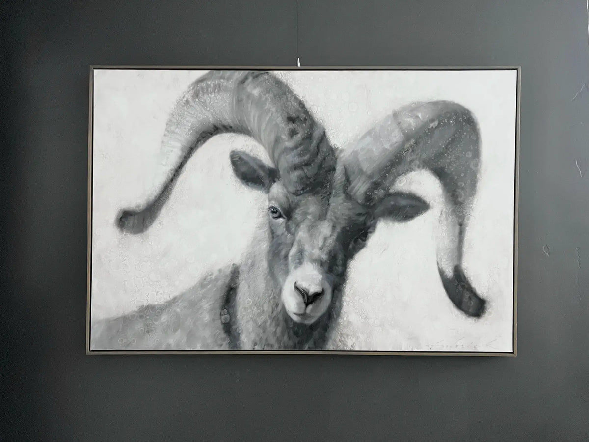 Framed artwork of a ram with large curved horns on a dark background