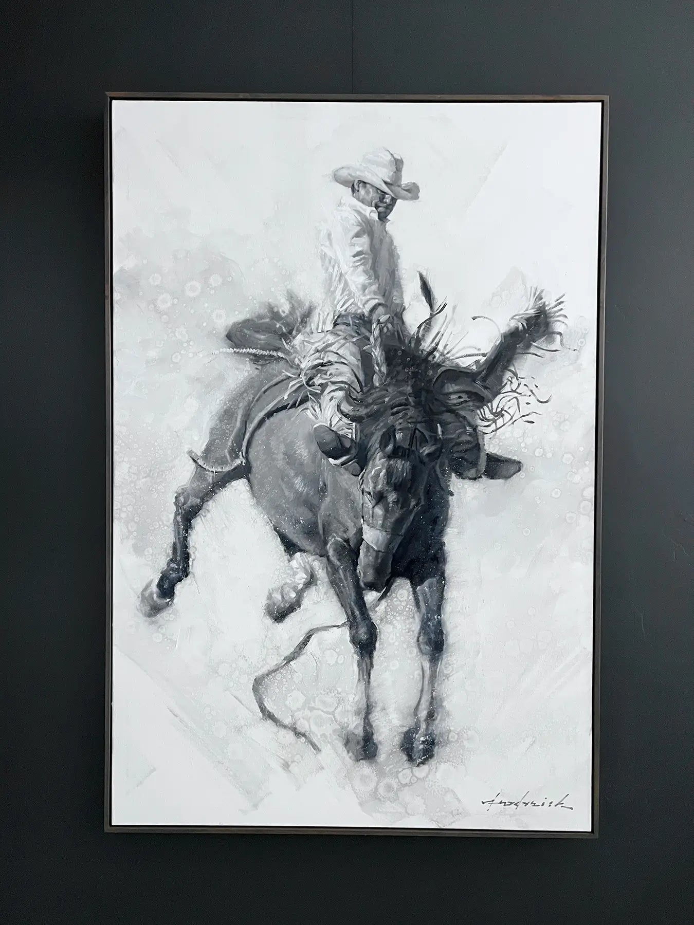 Framed artwork of a cowboy on a bucking horse against a dark background