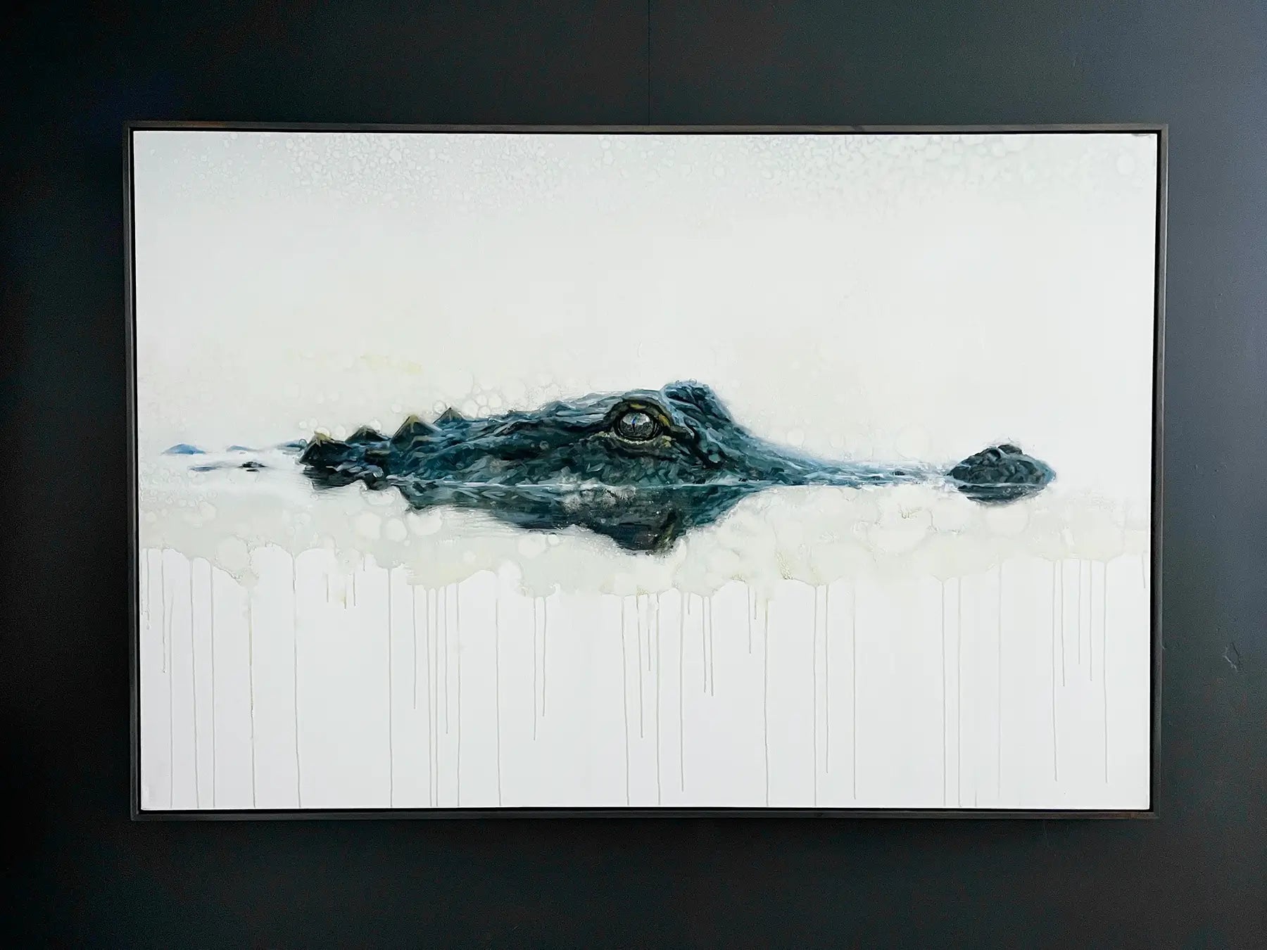 Framed artwork of an alligator partially submerged in water on a white background.